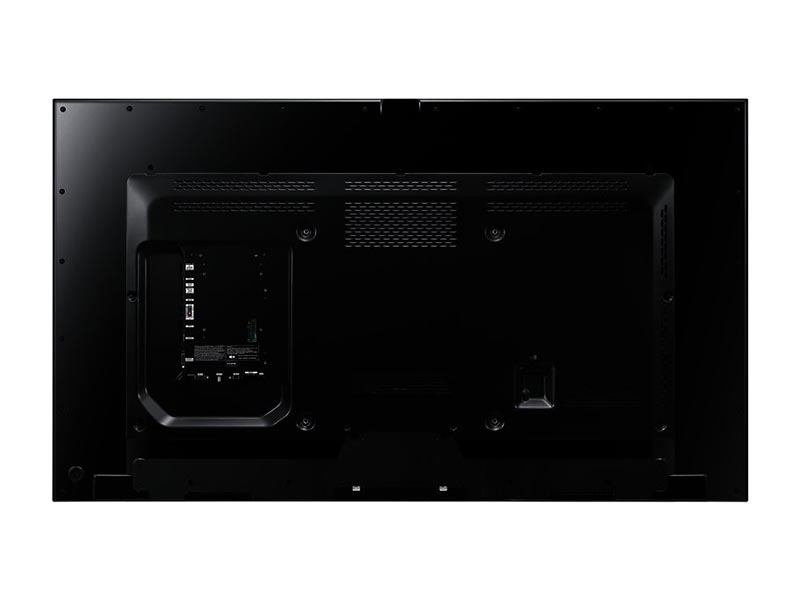 Back view of the 65 Inch Samsung ME65B LED LCD display for rent, showing left-side HDMI and USB ports, ventilation grills along the top and sides, and a central mounting bracket for wall or stand installation.