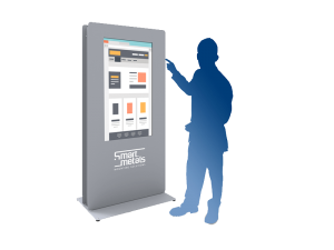 A person’s silhouette interacts with a tall, vertical touchscreen kiosk displaying a web interface. The kiosk is branded Smart Metals and features a sleek, modern design suitable for public or commercial spaces.