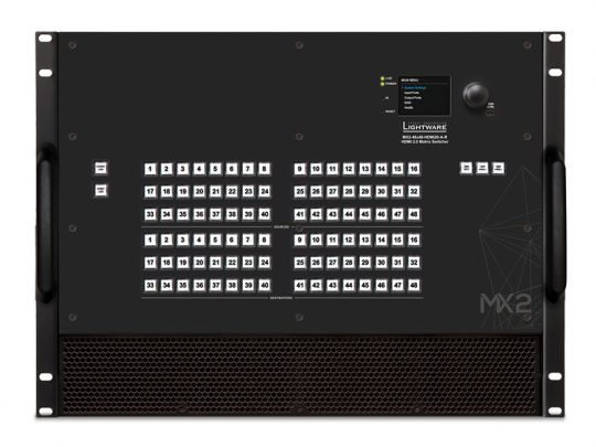 Front view of a Lightware MX2 Matrix Switcher showing its control panel with rows of numbered buttons, LCD display screen, indicator lights, rotary control knob, and sturdy side handles for easy rack mounting.
