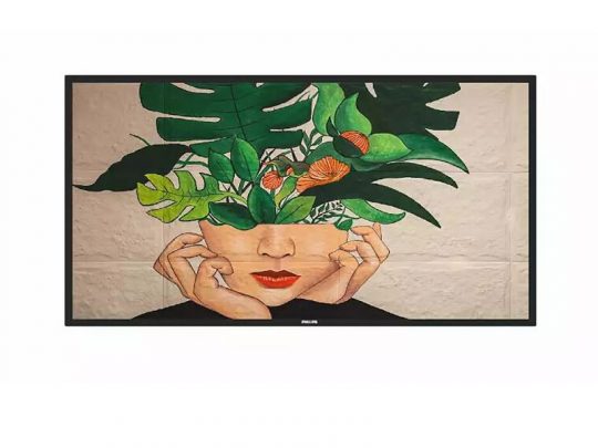 Framed artwork titled Floral Fusion Portrait featuring a persons face partially obscured by their hands, with vibrant green leaves and orange flowers sprouting from the top of their head, blending human and nature elements in a modern, botanical-inspired design.