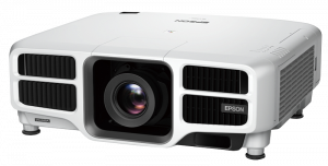 White Epson VALASKA projector featuring a prominent central lens, side ventilation grilles, and the Epson logo on the front right; VALASKA model name displayed on the lower left corner. Ideal for high-quality home or office projection.