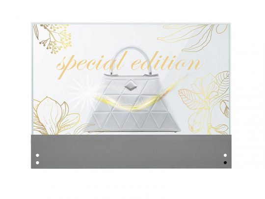 White geometric handbag with Special Edition in gold text, displayed on a gray base with floral line art in the background.