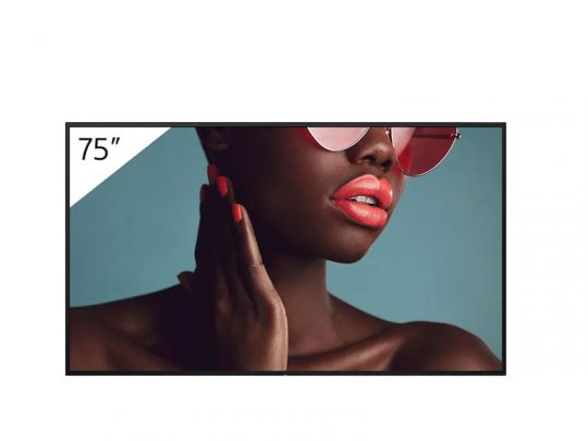 Close-up photo of a person wearing pink sunglasses, coral lipstick, and matching nail polish displayed on a 75-inch flat-screen TV. The vibrant image highlights the TV’s high-resolution display and color accuracy—ideal for showcasing beauty products or fashion accessories.