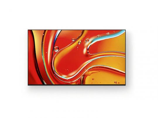 Samsung QLED flat-screen TV mounted on a white wall, displaying a vibrant abstract image with swirling red, orange, and yellow patterns featuring glossy, liquid-like textures and bubble details.
