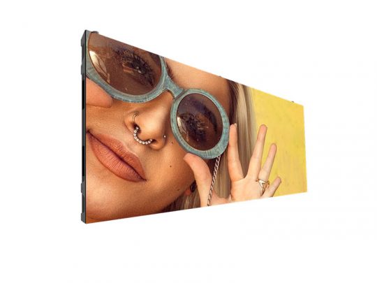 Rectangular display screen showing a close-up of a smiling person wearing round sunglasses and a nose ring, holding up a peace sign with their hand against a bright yellow background. Perfect for digital frame or smart display product listing.