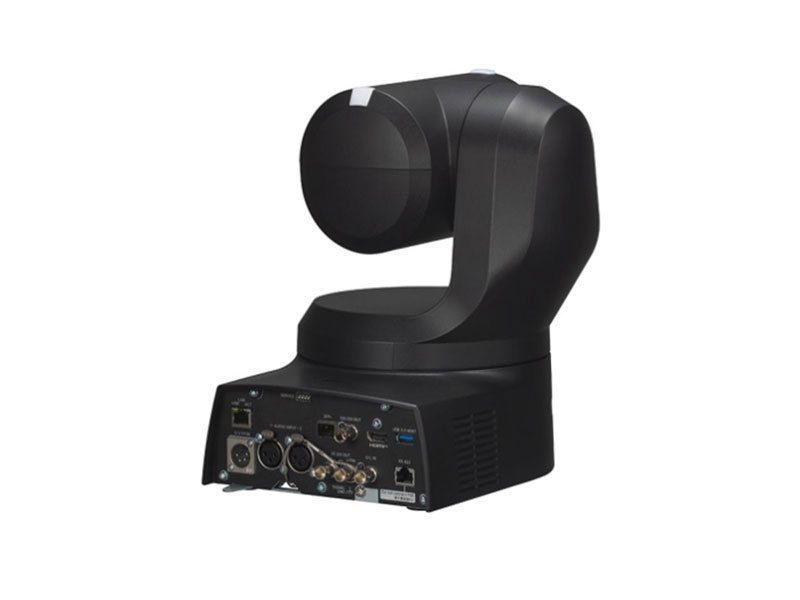 4K PTZ-Kamera Panasonic AW-UE160KEJ in Schwarz, abgebildet auf drehbarem Sockel vor weißem Hintergrund, mit gut sichtbaren Ein- und Ausgängen auf der Rückseite - professionelle Kamera zum Mieten für hochwertige Videoaufnahmen.